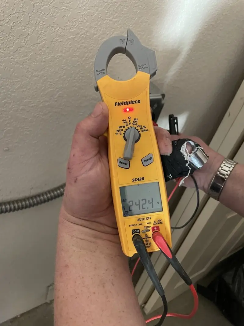 Voltage testing with clamp meter during Outlet Installation in Bourne